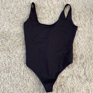 Black spandexy bodysuit.